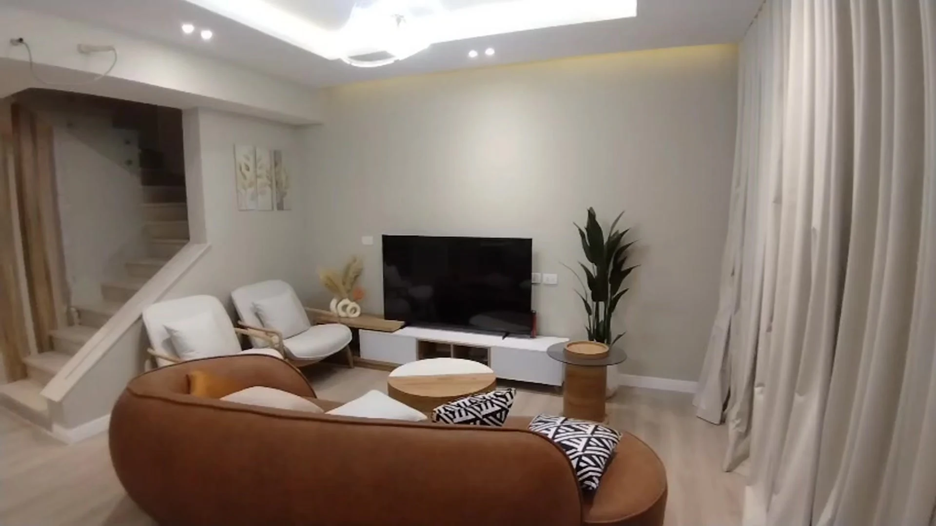 The brown-sofa living room in the Larimar 1 show villa
